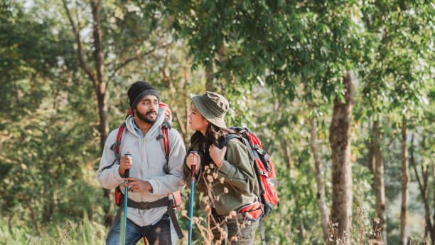 istock Travelers hiking with backpack traveling in forest wild and look around and explore while walking in nature wood. happy holiday vacation trip. 1488771635