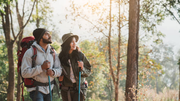 istock Travelers hiking with backpack traveling in forest wild and look around and explore while walking in nature wood. happy holiday vacation trip. 1488772230