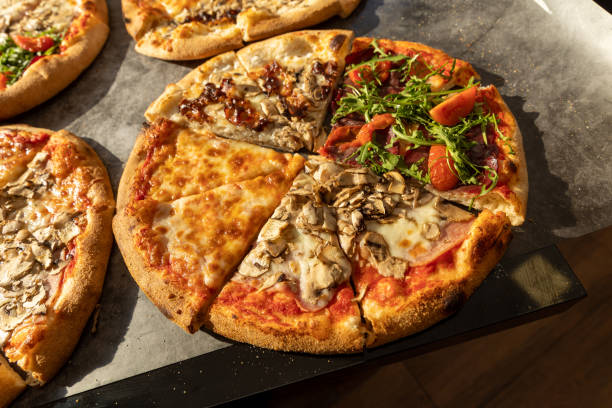 istock Delicious pizzas cut  slices on stone table 1488775668