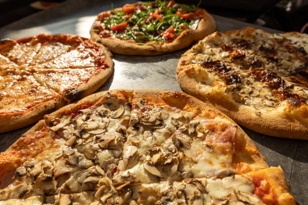 istock Delicious pizzas cut  slices on stone table 1488775669
