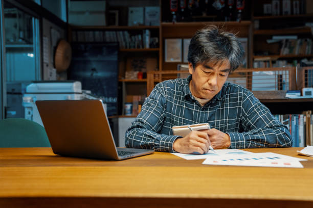 istock Mature male entrepreneur looking at monthly finances on a laptop computer 1488776482