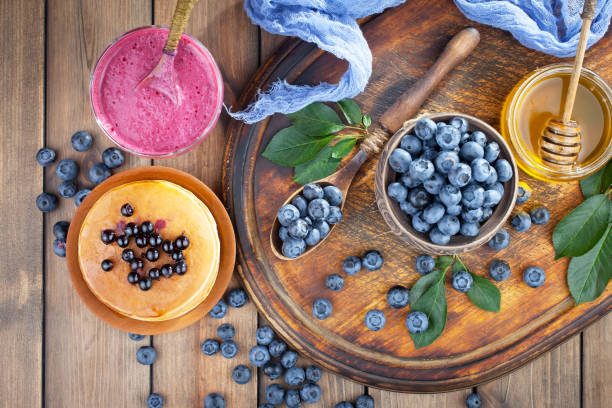 Blueberries in a cup on an old background.