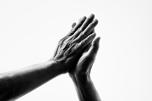 Black and white photo of wrinkled hands of senior generation