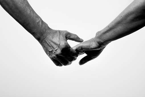 Black and white photo of wrinkled hands of senior generation