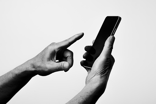 Black and white photo of wrinkled hands of senior generation