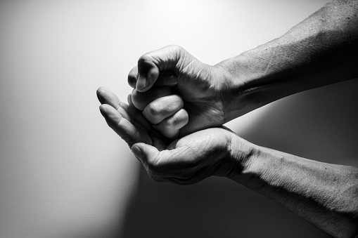 Black and white photo of wrinkled hands of senior generation