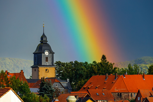 Herleshausen, Hesse, Germany - September 17, 2022: The Church Tower of Herleshausen with a Rainbow