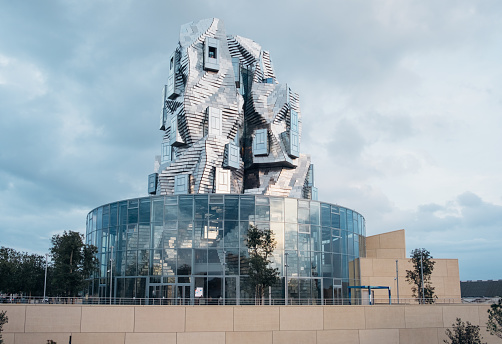 Arles, France - October 2022: Twisting tower in reflective aluminium panels designed by architect Frank Gehry for Luma Foundation arts centre. Contemporary architecture.