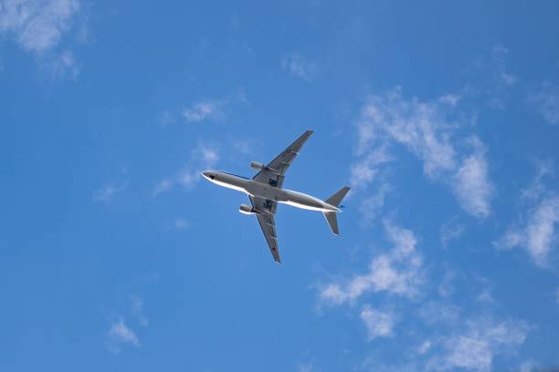 istock Low angle shot of an airplane flying through a sky 1488783924