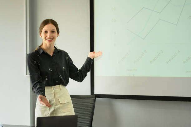 istock Professional business pointing at projector screen, explaining project strategy at corporate meeting. 1488785469