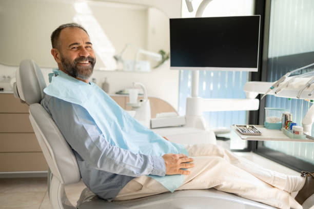 istock Happy man having a dental appointment at dentist's office. 1488786807