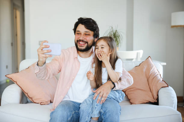 istock Father and daughter taking selfie together 1488790009