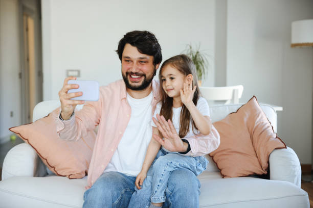istock Father and daughter taking selfie together 1488791120