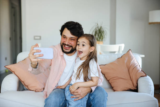 istock Father and daughter taking selfie together 1488791622