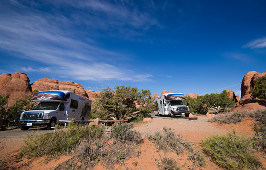 Two Cruise America RVs in a campground in Utah