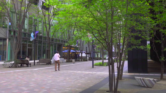 People strolling along the lush green shopping street. Marunouchi,Tokyo