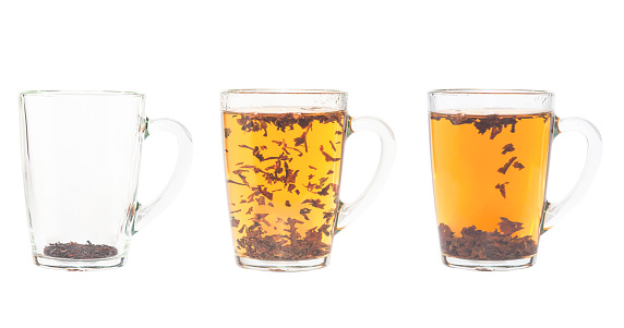 Three transparent cups of black tea.