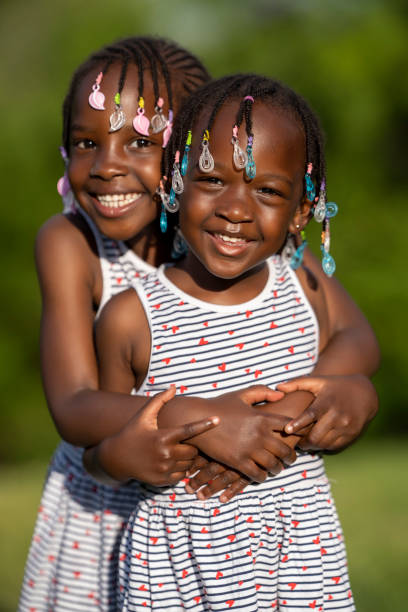 istock Two black skinned sisters playing posing to camera in a sunset 1488800366