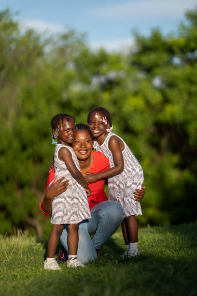 istock Two black-skinned sisters sunset with their mom 1488800395
