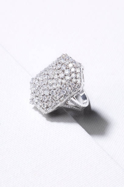 istock Ring made of white gold decorated with precious stones on a white background. 1488800424