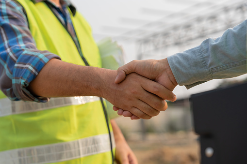 Construction worker team hands shaking greeting start up plan new project contract in office center at construction site, industry ,architecture, partner, teamwork, agreement, property, contacts.