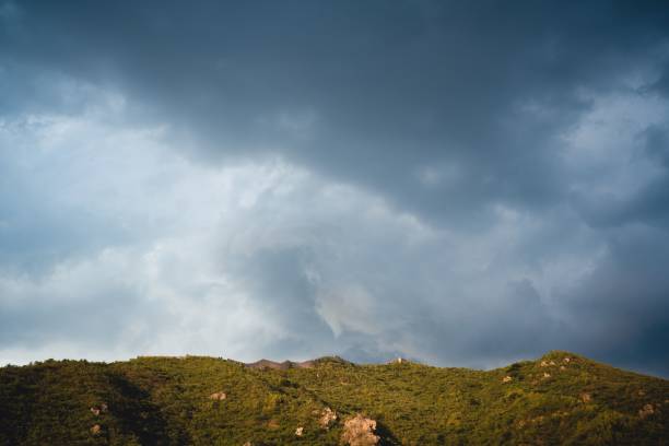 istock there are clouds over a mountain as the sun sets in 1488804883