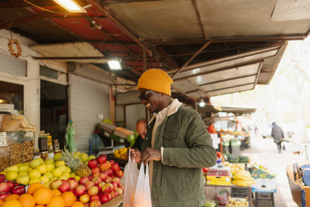 istock Young man at fruit and vegetable stand 1488804986