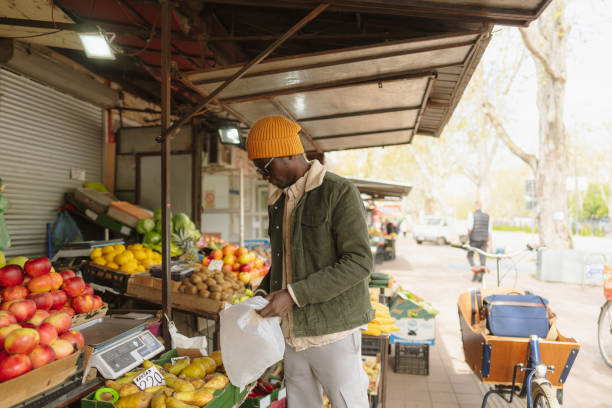 istock Young man at fruit and vegetable stand 1488804997
