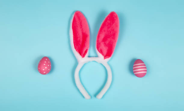 istock easter holiday background with bunny ears on blue background. copy space 1488807579