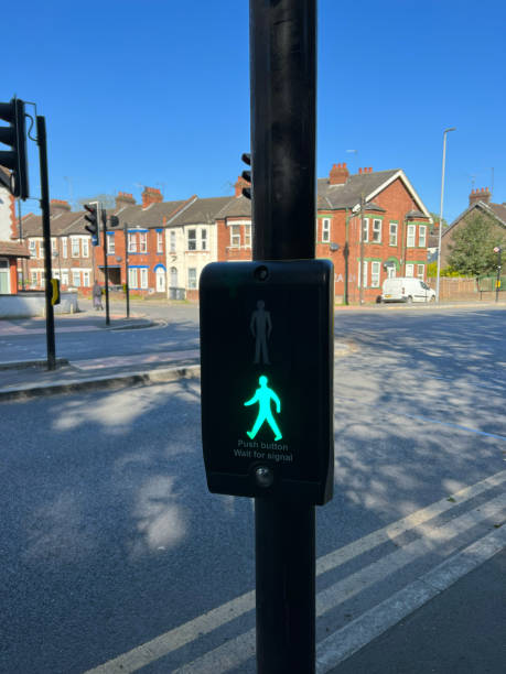 istock Pedestrian traffic light control button at crosswalk showcasing red person for safe road crossing. Pedestrian safety in the big city of London. Crosswalk button for pedestrian. 1488809717