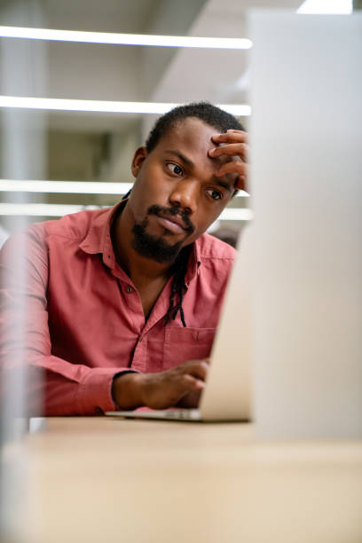 istock Stressful job. Stressed african businessman working at laptop, having problem at workplace. 1488809824
