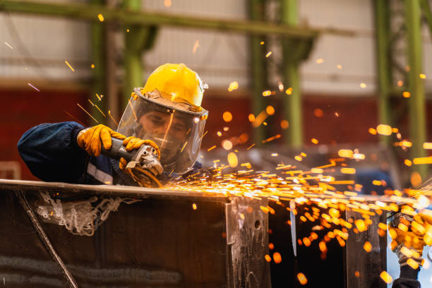 Metal worker using a grinder Metal worker using a grinder steel grinding stock pictures, royalty-free photos & images