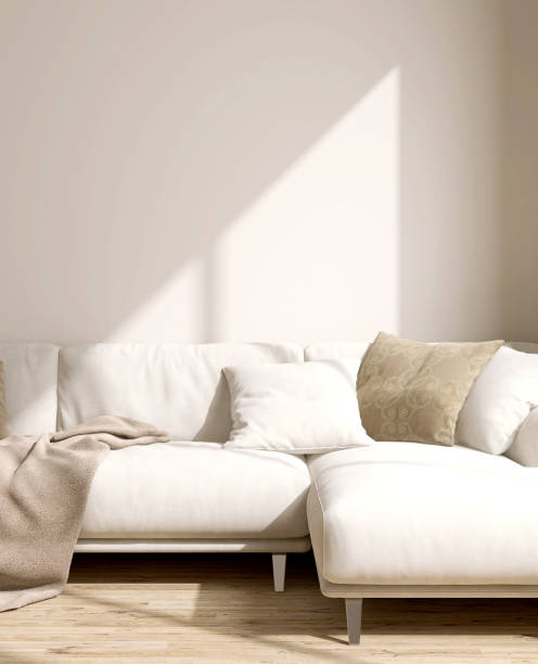 istock Cream comfortable suede leather sofa, brown cushion, blanket in sunlight on blank beige wall, parquet floor 1488812913