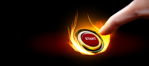 Human hand pressing on red start button with fiery flames on dark background, copy space. 3D rendering