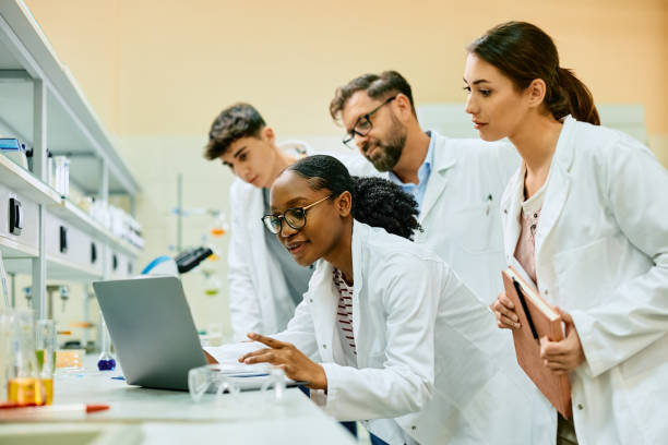 istock Team of scientist cooperating while analyzing data on laptop in a laboratory. 1488815614