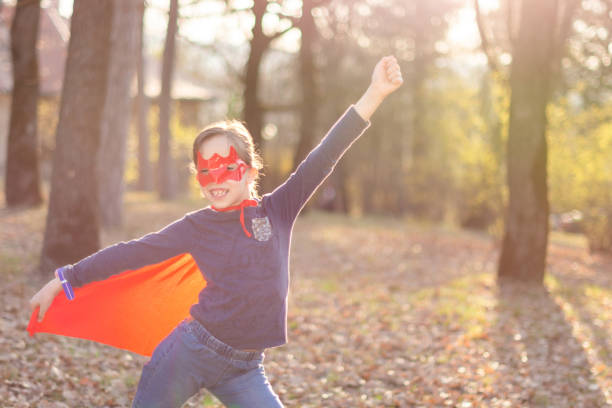 istock Superhero child standing in park 1488815678