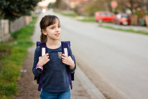 istock Portrait of smiling elementary school girl with her backpack 1488815728