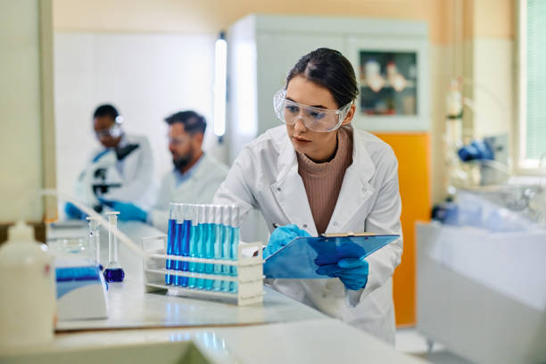 istock Young female scientist analyzing chemical substances in test tubes in a lab. 1488815827