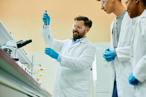 istock Happy science teacher and his students during an experiment in laboratory. 1488815928