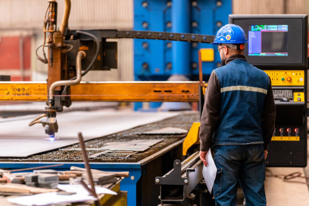 istock Steel worker on CNC plasma cutter machine 1488817643