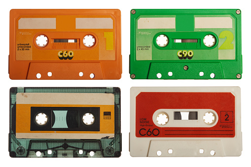 Group of old retro cassette tapes. Collecttion of various vintage 80's music tapes isolated on white background