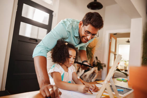istock Homework, father or girl learning drawing skills, bonding or homeschooling work in interracial family. Proud Indian dad, teaching art or creative kid writing on paper in child development education 1488819355