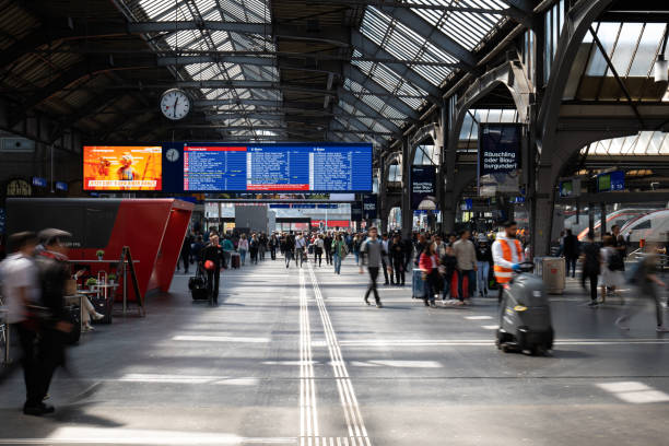 Train schedule display inside Zurich or Zürich train main station on 05-04-2023. Long exposure, blurred, unrecognizable people Train schedule display inside Zurich or Zürich train main station on 05-04-2023. Long exposure, blurred, unrecognizable people. zurich train station stock pictures, royalty-free photos & images