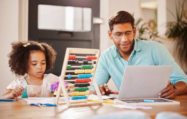 istock Remote work, laptop and father and child with homework, elearning and help with studying. Support, together and dad helping a girl kid with education, technology information and teaching at home 1488821433