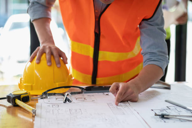 istock Asian engineers brainstorm and measure to document cost estimates and write floor plans for architectural and engineering designs for houses and buildings. 1488822334