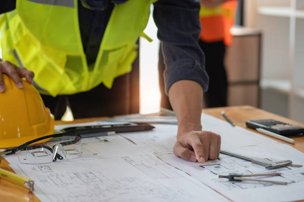 istock Asian engineers brainstorm and measure to document cost estimates and write floor plans for architectural and engineering designs for houses and buildings. 1488822889