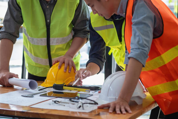 istock Asian engineers brainstorm and measure to document cost estimates and write floor plans for architectural and engineering designs for houses and buildings. 1488822961