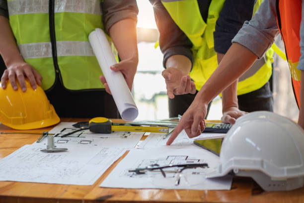 istock Asian engineers brainstorm and measure to document cost estimates and write floor plans for architectural and engineering designs for houses and buildings. 1488823025