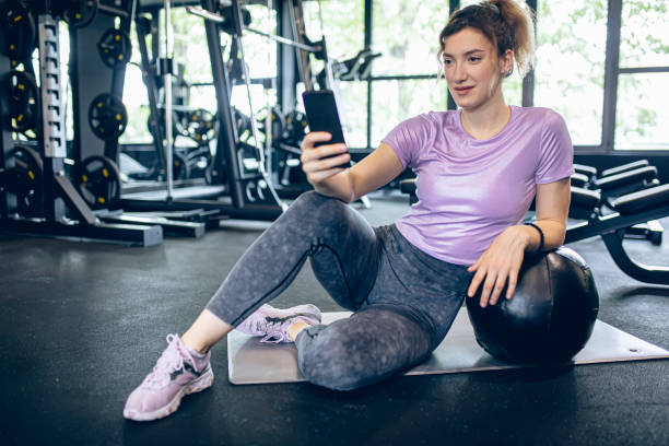 istock Young female athlete using smartphone in the gym 1488824229