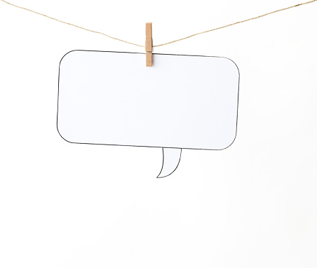 Blank speech bubble hanging with a clothesline against a white background.